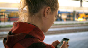 Person looking at their phone on the street